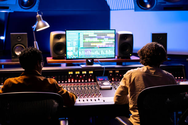 istock Team of singer and composer working on track recording in studio 2148357688
