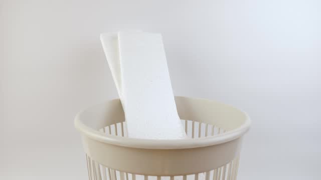 Pieces of Styrofoam are thrown into the trash can. Disposal of household waste.