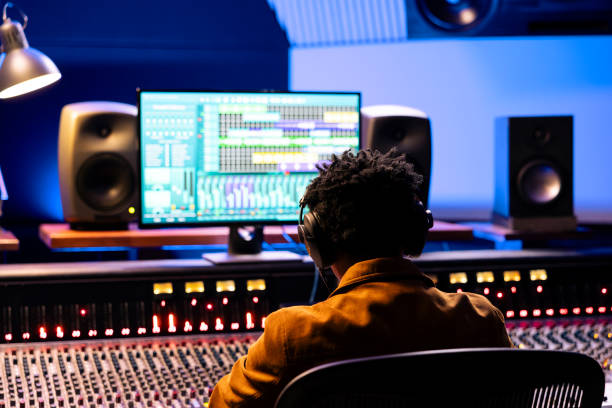 istock African american sound engineer editing tracks in control room at studio 2148357799