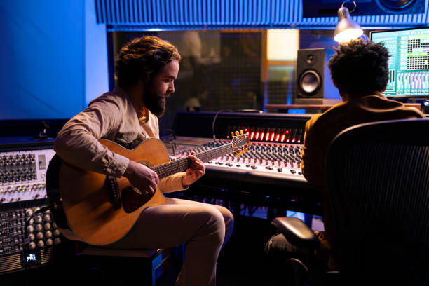 istock Singer creating a new hit song in studio with guitar running 2148357914