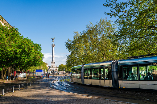 Bordeaux, France - April 8th, 2024: Tram is passing bye at  Bordeaux. Passengers are waiting for the tram.