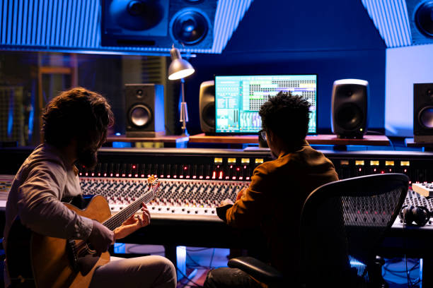 istock Artist playing electro acoustic guitar in control room at studio, 2148358085