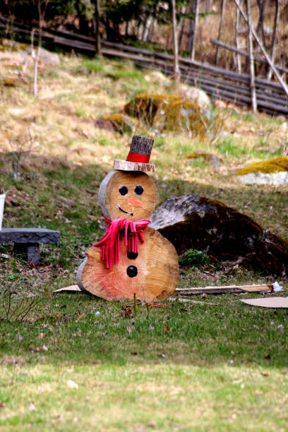 istock A tree snowman standing outside in the summer 2148358248