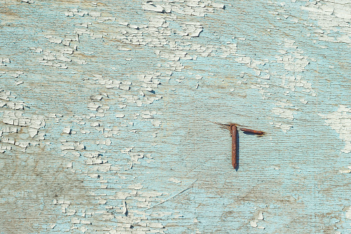 Wooden surface with old blue paint. Close-up. Background. Texture