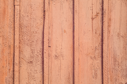 The texture of old wooden planks with strips. Painted in red