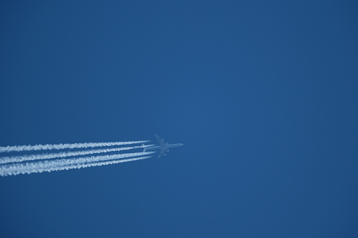 Airplane in the blue sky with trace of aeroplane.