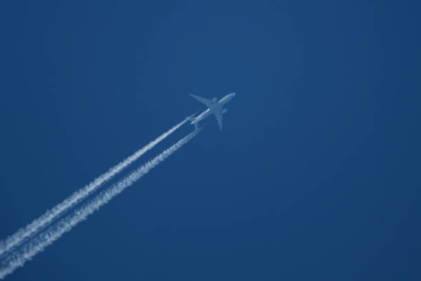 istock Airplane in the blue sky with contrail 2148359018