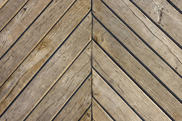 Old boards are located at an angle. Fragment of the pier. Background