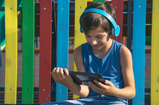 Child playing video game on the sport playground