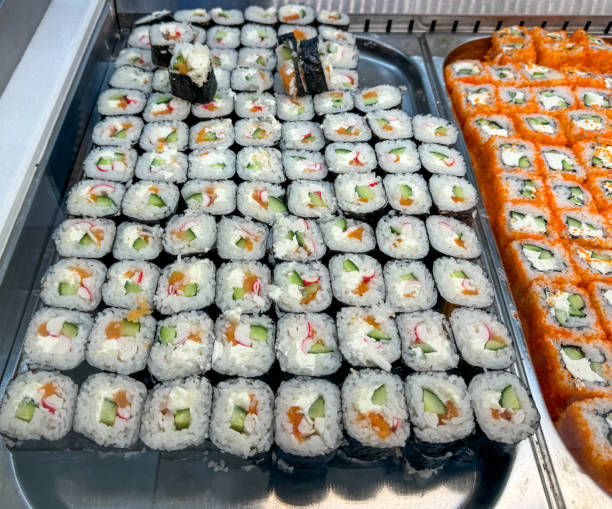 istock Sushi and rolls on a counter in a market 2148362923