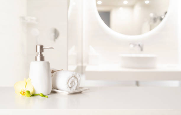 istock Soap dispenser and towel on table with free space in blurred bathroom 2148365429
