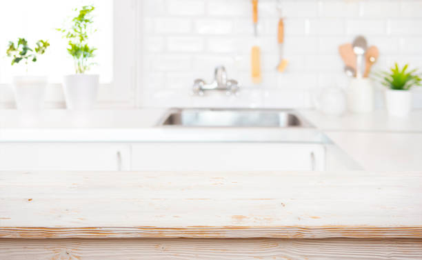 istock Wood table top on blur kitchen room sink background for product display montage 2148365449