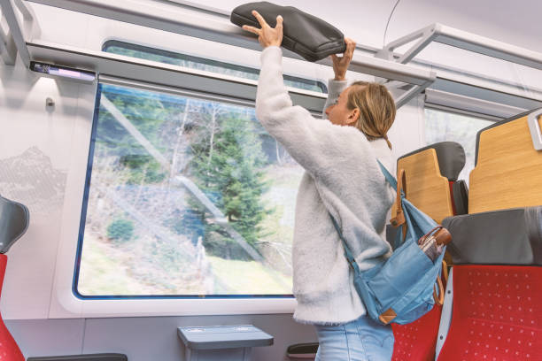 istock Traveler Securing Luggage Overhead 2148365551
