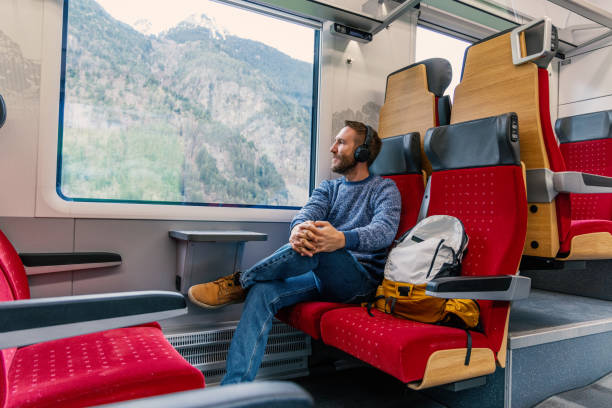 istock Young man enjoying the view from a train's window 2148365768