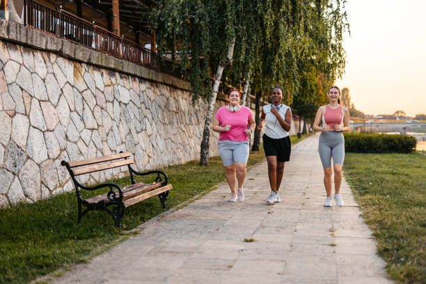 istock Three Young Female Friends Jogging On The Quayside 2148366049