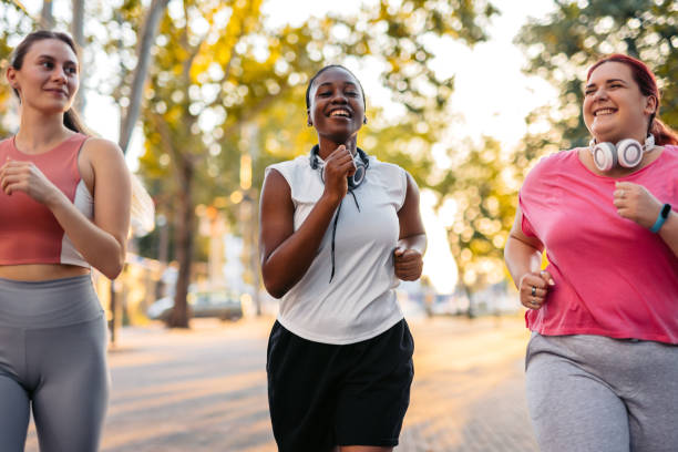 istock Three Young Female Friends Jogging In The Park 2148366227