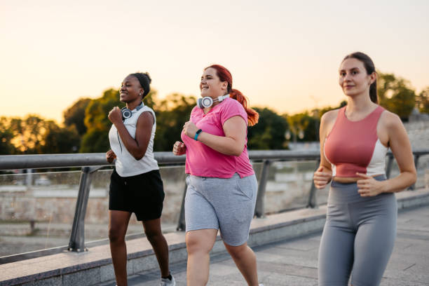 istock Three Young Female Friends Jogging On The Bridge 2148366281