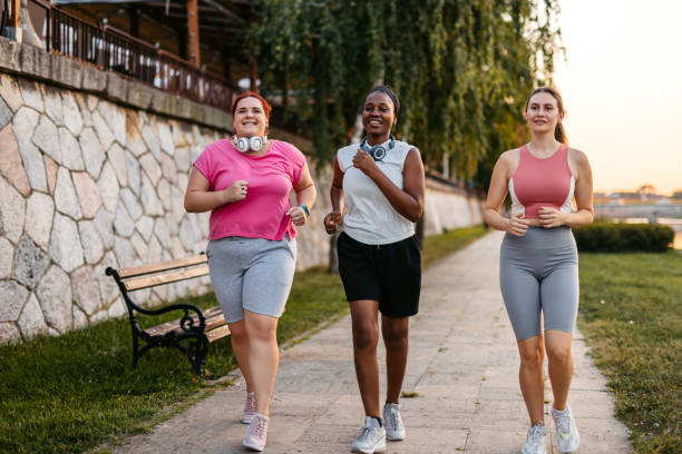istock Three Young Female Friends Jogging On The Quayside 2148366386