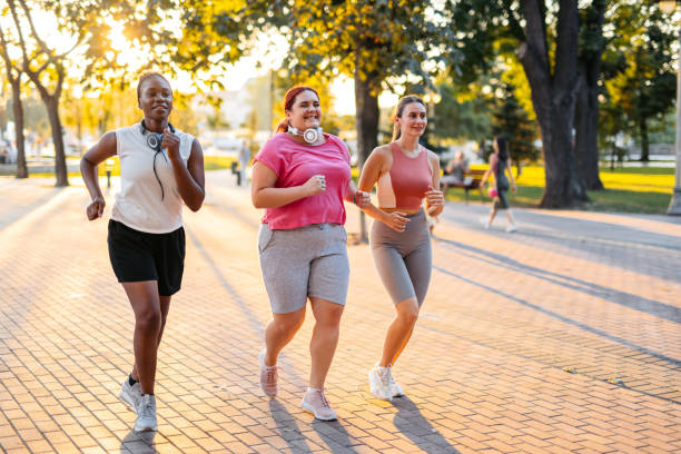 istock Three Young Female Friends Jogging In The Park 2148366485