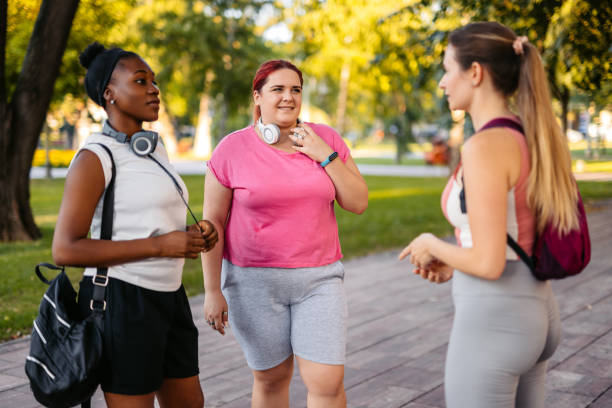 istock Three Young Female Friends Talking Before Jogging In The Park 2148366566