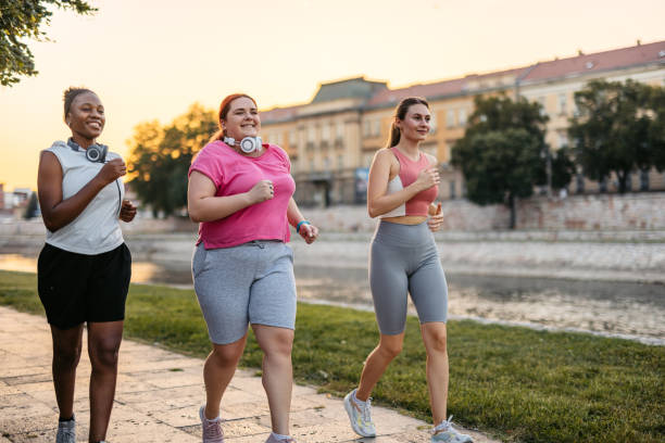 istock Three Young Female Friends Jogging On The Quayside 2148366587