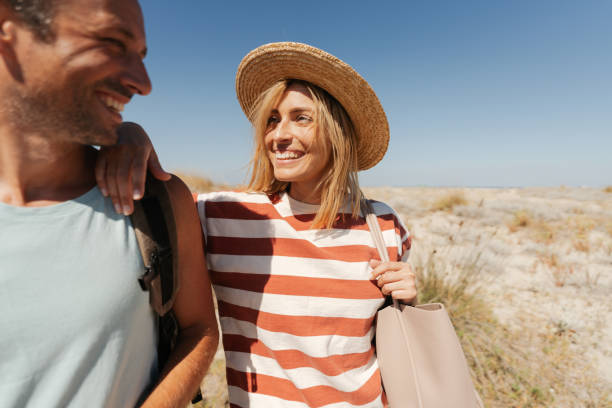 istock Loving couple exploring new sandy beach together 2148367493