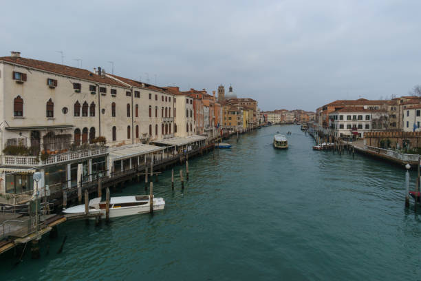 vista sobre el canal grande desde el ponte degli scalzi con barcos en un día de invierno frente a las fachadas de los edificios típicos, venecia, véneto, italia - ponte degli scalzi fotografías e imágenes de stock