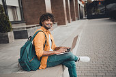 Photo of cheerful joyful nice man dressed stylish clothes using modern wireless device macbook working remotely spring day outdoor