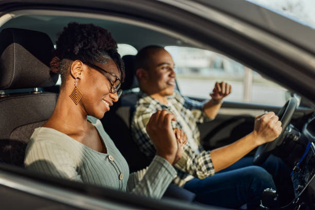 istock Cheerful black couple having fun on a trip in a car. 2148369796