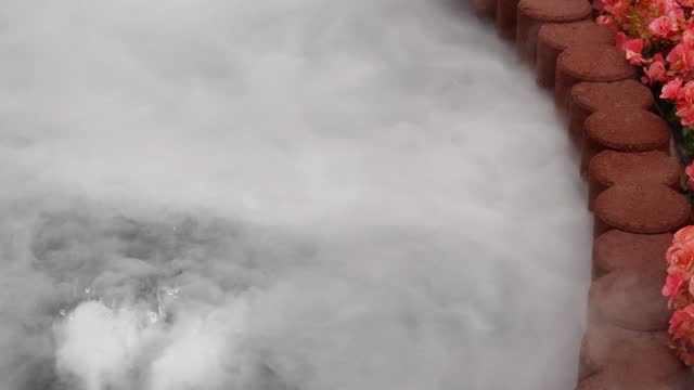 Video footage of white mist used to decorate the base of the fountain to create a beautiful atmosphere on the water surface.