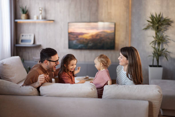 istock Happy family having fun on sofa at home. 2148372272