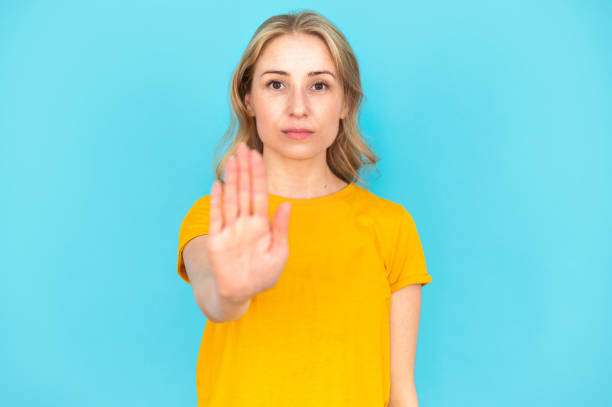 istock Woman saying no, showing stop gesture by hand 2148373152