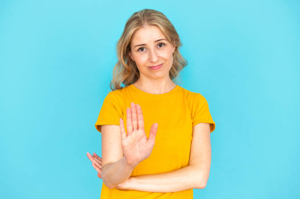 istock Young woman making hand stop sign, showing disagreement gesture 2148373158