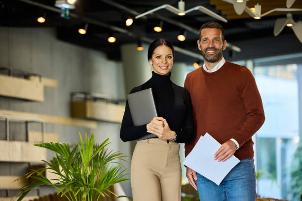 istock Portrait of an elegantly dressed business people, holding some documents and a laptop. 2148373790