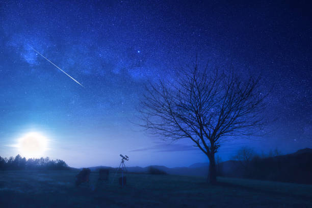 istock Full Moon rising behind the tree silhouettes in a countryside landscape. 2148373796