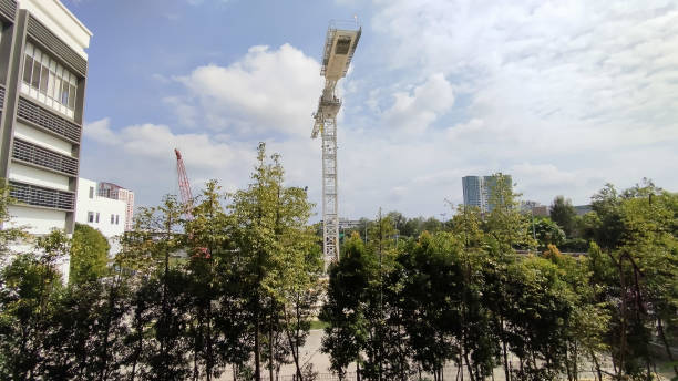 istock tower crane towering over a lush of green trees 2148373939