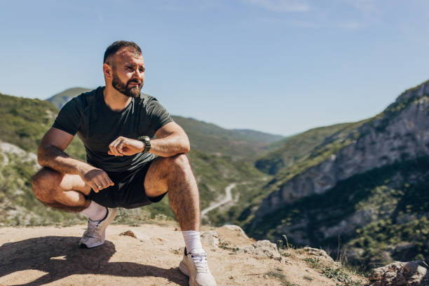 istock Mid adult man warming up and stretching before mountain running 2148375368