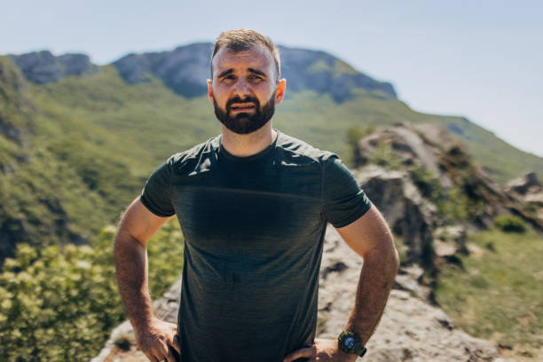 istock Mid adult man warming up and stretching before mountain running 2148375404