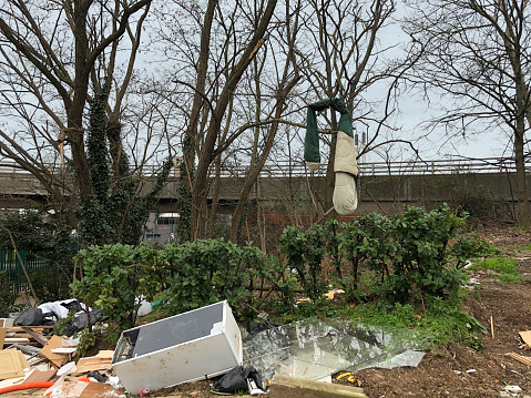 Rubbish dumped on waste ground by the side of the North Circular Road in London