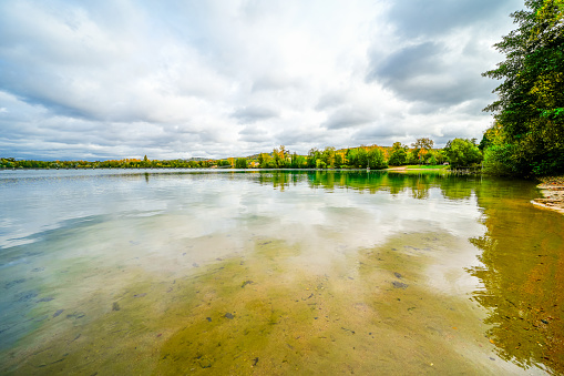 Baggersee Weingarten near Karlsruhe with the surrounding nature. Autumn landscape by the lake.
