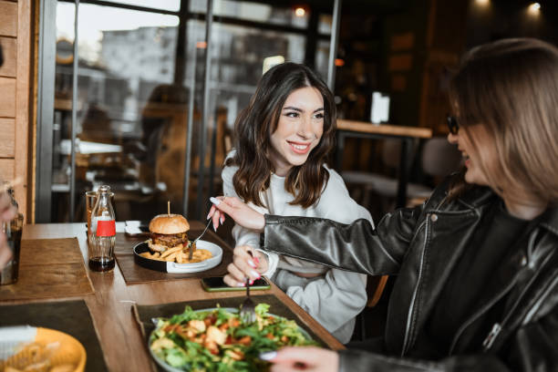 istock Cute Lesbian Couple Sharing Their Food 2148379595