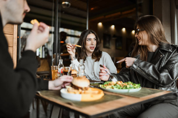 istock Food Sharing Proposal By Smiling Female Friends 2148379733