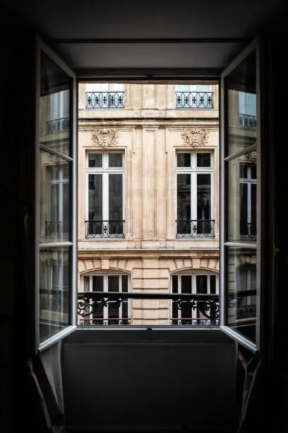 Opening of hotel window overlooking an old and historic building at Bordeaux, France
