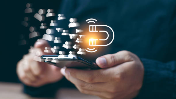 istock Digital Marketing Media Technology Graphic Concept, Business Lead And Customer Generation Magnet Pulling Figures, Businessman using mobile smart phone 2148381509