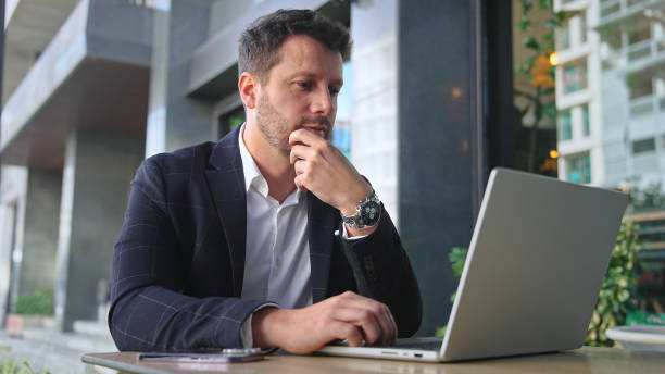 Successful businessman work at cowork cafe. Business man type computer mackbook.