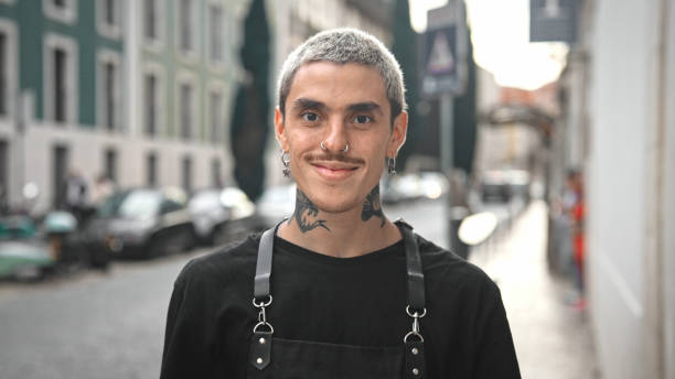tattooed barista portrait. smiling hipster barber happy bartender waiter outdoor - piercing stock-fotos und bilder