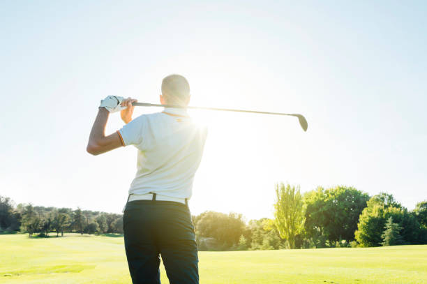 istock Male golf player teeing off golf ball from tee box to beautiful sunset 2148383677