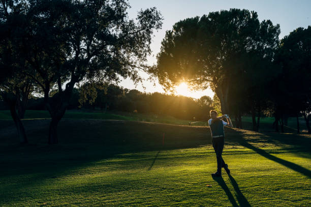 istock Male golf player teeing off golf ball from tee box to beautiful sunset 2148383709