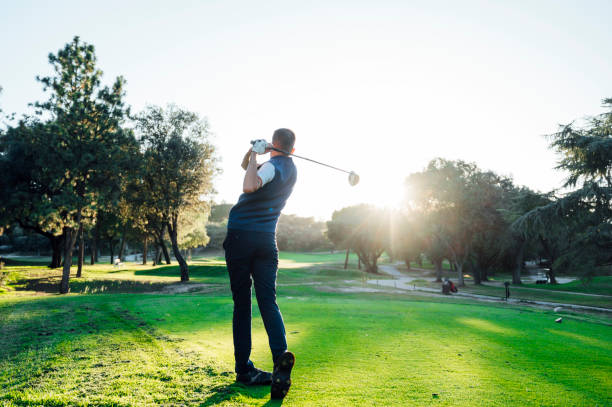 istock Male golf player teeing off golf ball from tee box to beautiful sunset 2148383712
