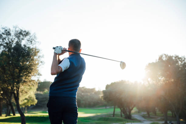 istock Male golf player teeing off golf ball from tee box to beautiful sunset 2148383714